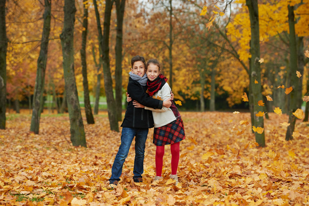 boy and girl in autumn park - Фото, изображение