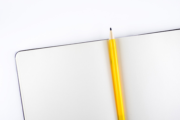 Open blank notebook with yellow pencil - Fotó, kép