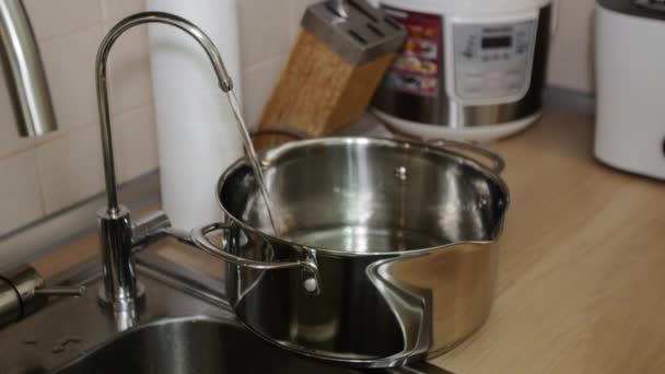 Woman fills a pan with water - Footage, Video