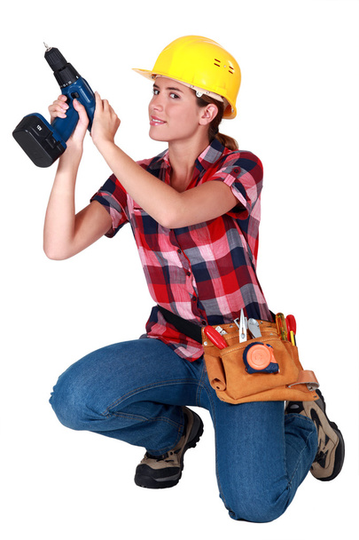 Craftswoman holding a drill - Fotoğraf, Görsel