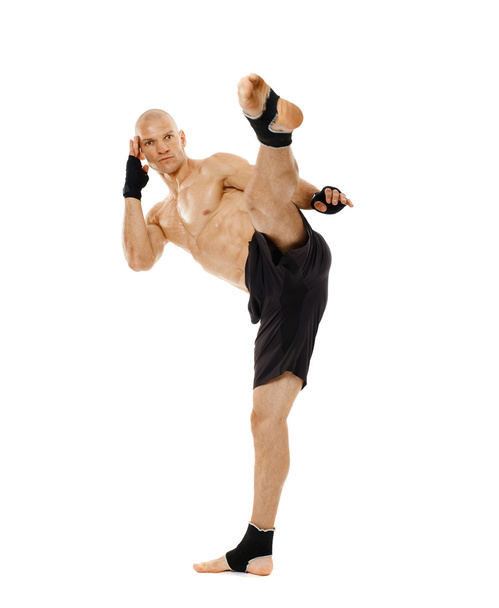 Kickboxer executing a powerful kick - Foto, Imagen
