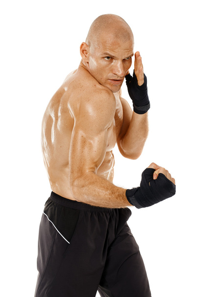 Very fit kickboxer punching - Фото, зображення