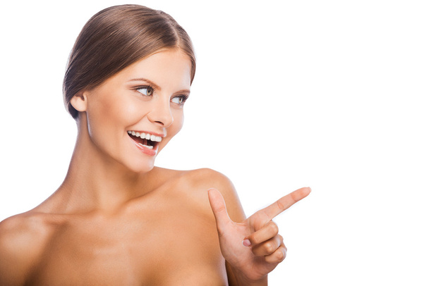 shirtless woman pointing away and smiling - Zdjęcie, obraz