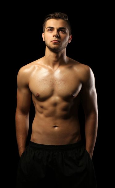 Muscle young man on dark background - Photo, Image