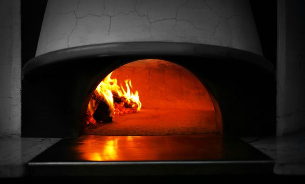 Traditional pizza in oven at restaurant - Photo, Image