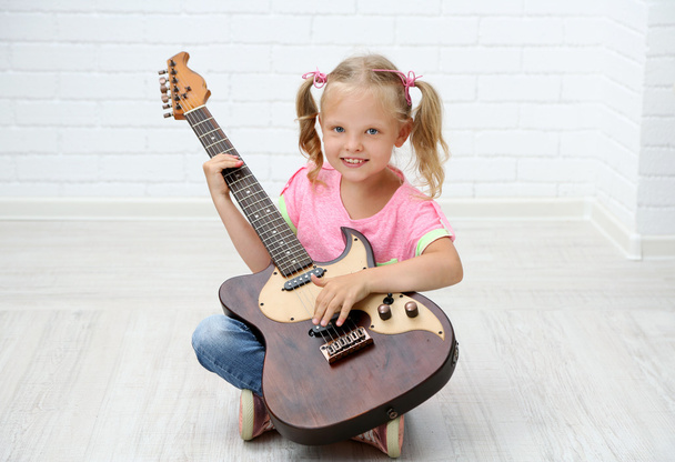 Little girl playing guitar - Fotó, kép