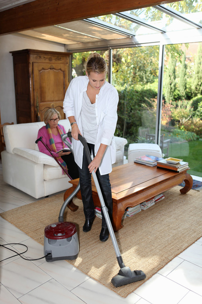 Young woman vacuuming - Фото, зображення