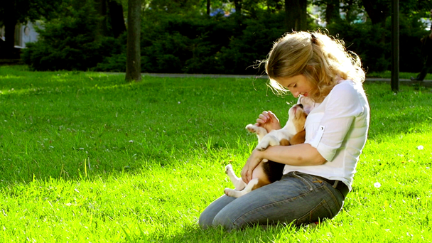 Portrait of a woman with her beautiful beagle  dog outdoors - Video, Çekim
