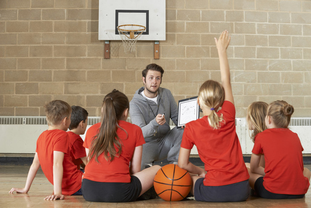Coach Giving Team Talk To Elementary School Basketball Team - Photo, image