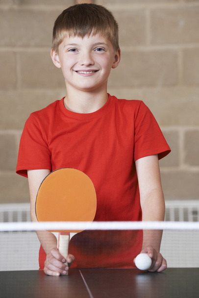 Portrait Of Boy Playing Table Tennis In School Gym - Foto, immagini