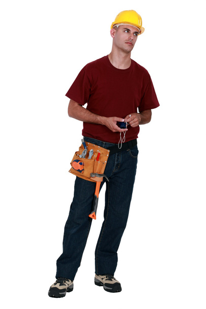 A very annoyed tradesman holding a chalk line - Foto, immagini