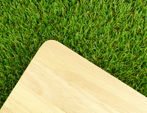 Wood board on green grass - Fotoğraf, Görsel