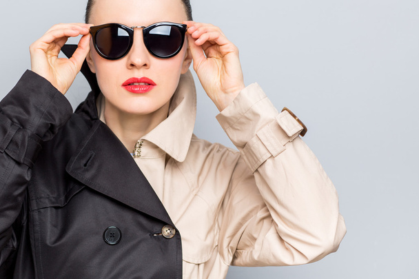 Stylish lady in sunglasses and rain coat - Fotó, kép