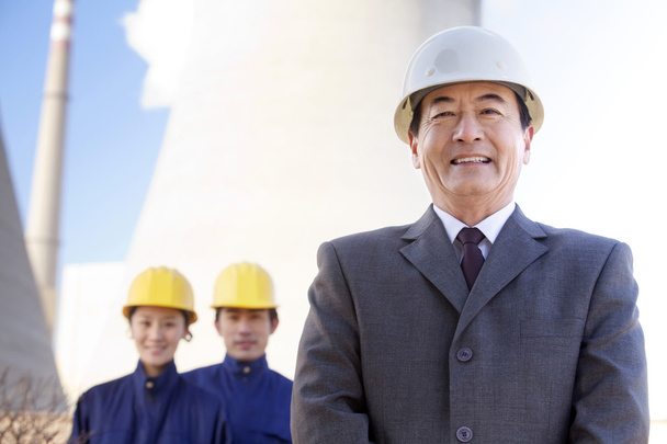 Businessman and workers in hardhats - Photo, Image