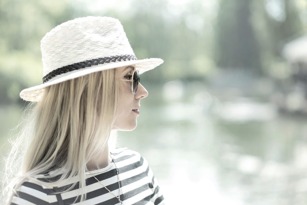 Portrait of blond woman in white hat - Fotó, kép