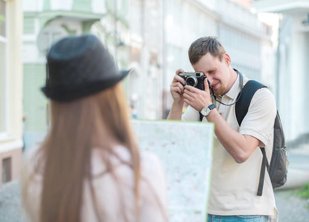 man shooting woman with map - 写真・画像