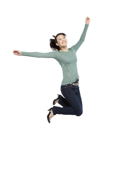 Portrait of an excited young woman mid-air - Φωτογραφία, εικόνα
