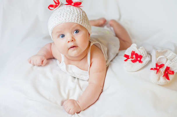 happy baby girl dressed in knitted bunny costume - 写真・画像