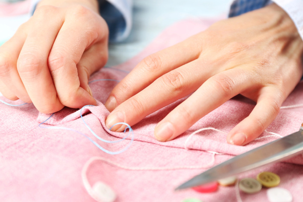 Closeup hands of seamstress at work - Photo, Image