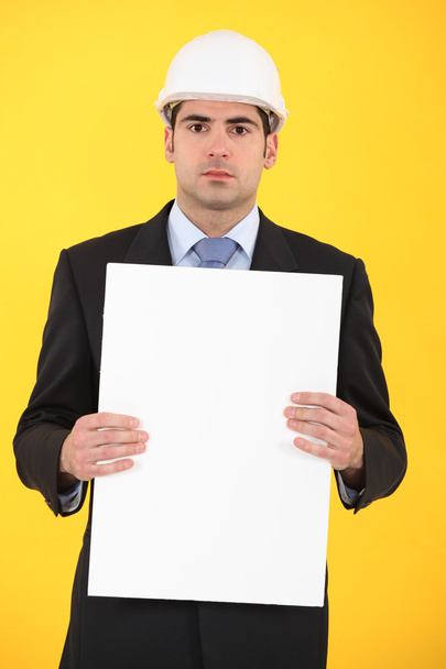Architect holding blank advertising panel - Photo, Image