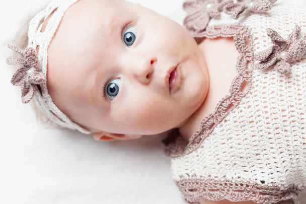 happy baby girl dressed in knitted pretty costume - 写真・画像
