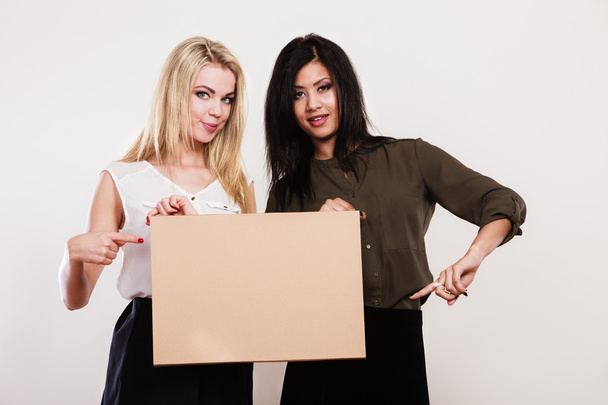 two women with blank board - Foto, Bild