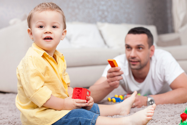 Pretty child is playing with his father - 写真・画像