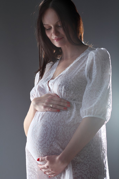 Pregnant female holding her breasts - Foto, imagen