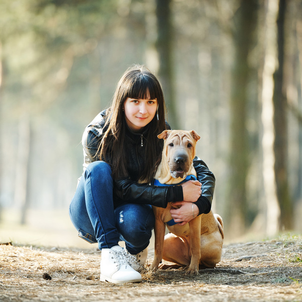 girl with dog in the park - Фото, изображение