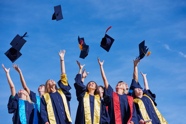 high school graduates tossing up hats - Фото, зображення
