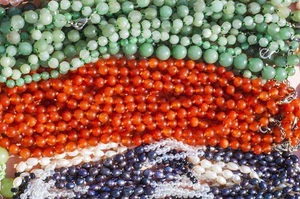 bead, chaplet, beading. a small piece of glass, stone, or similar material, typically rounded and perforated for threading with others as a necklace - Photo, Image