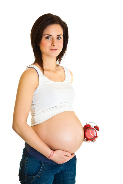Pregnant girl with clock due date concept - Foto, immagini