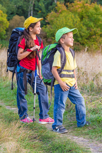 Two traveling kids with backpacks - Фото, изображение