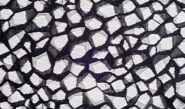 texture lace. a fine open fabric, typically one of cotton or silk, made by looping, twisting, or knitting thread in patterns and used especially for trimming garments. - Photo, Image
