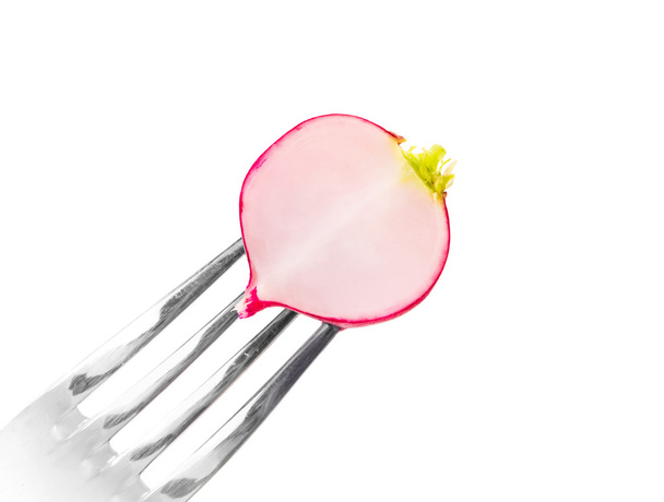 Fresh radish on a fork. Isolated on a white background. - Photo, Image