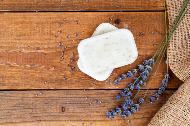 Bars of soap with lavender on a rustic wooden background - Фото, зображення