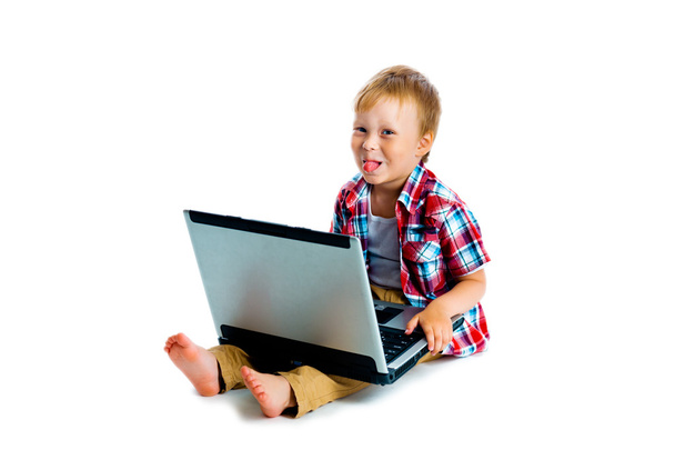 little boy with a laptop sitting on the floor - Fotografie, Obrázek