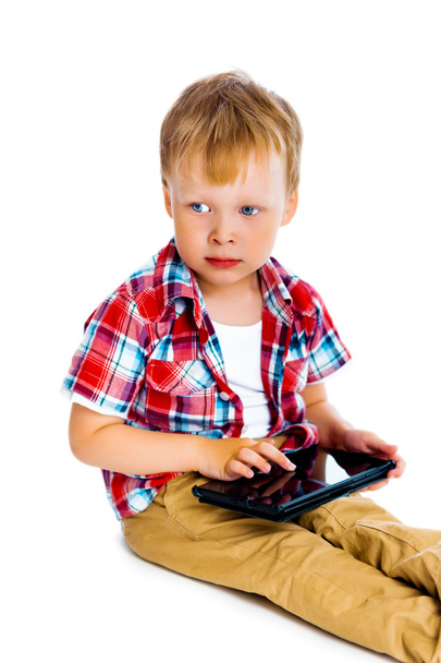 boy with a Tablet PC sitting on the floor - Photo, image