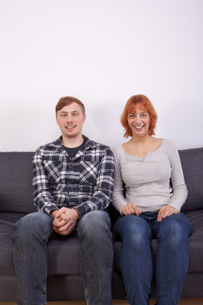 A young couple on a sofa - Zdjęcie, obraz
