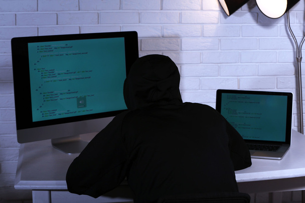 Hacker with computer and laptop  - Fotoğraf, Görsel