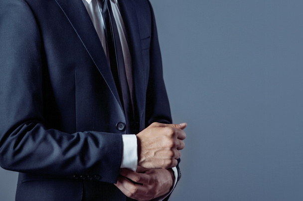 man in suit on a grey background, hands closeup - Photo, Image