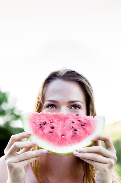 Woman eating a watermelon - Fotoğraf, Görsel