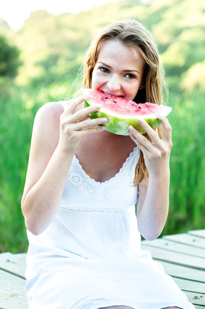 Beautiful woman eating watermelon in the park  - Fotoğraf, Görsel
