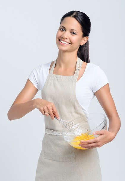 Woman chef beating eggs in a glass bowl - Zdjęcie, obraz