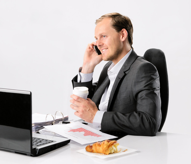 Busy businessman talks on cell phone - Фото, изображение