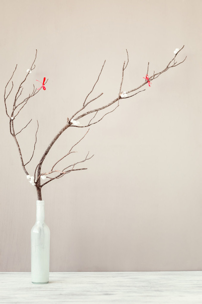 Bare branch in white vase on table top - Zdjęcie, obraz