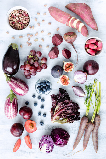 Assorted purple toned fruits and vegetables - Фото, изображение