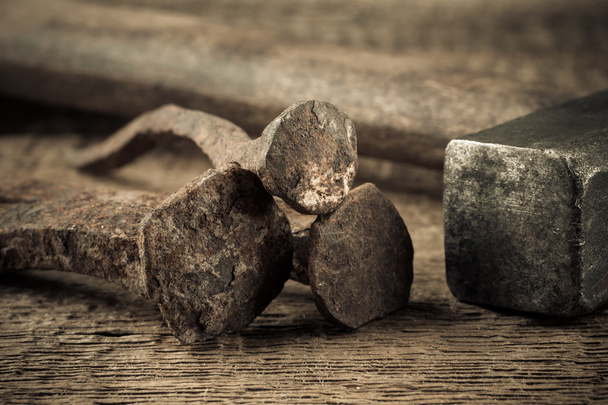 Vintage hammer with nails on wood background - Photo, Image
