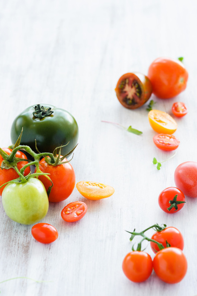 tomatoes on rustic background with leaves - Foto, Imagem