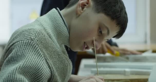 Boy 12 Years of Age is Making The drawing, Child's Hands are Smoothing out the Wires with Wire Cutters, Wires on a Model of Plane with Electric Motor - Кадры, видео